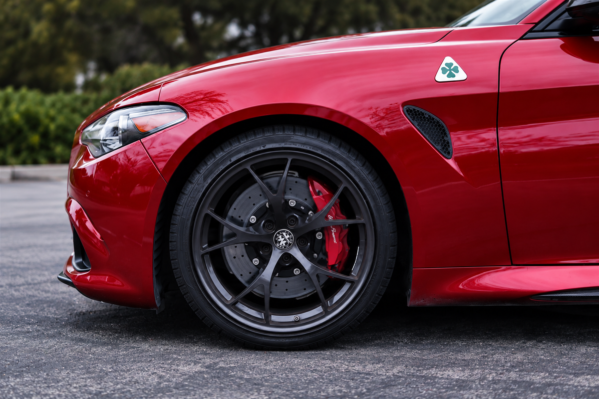 Owner's red car, AI-retouched photograph focusing on the front wheel and brake assembly