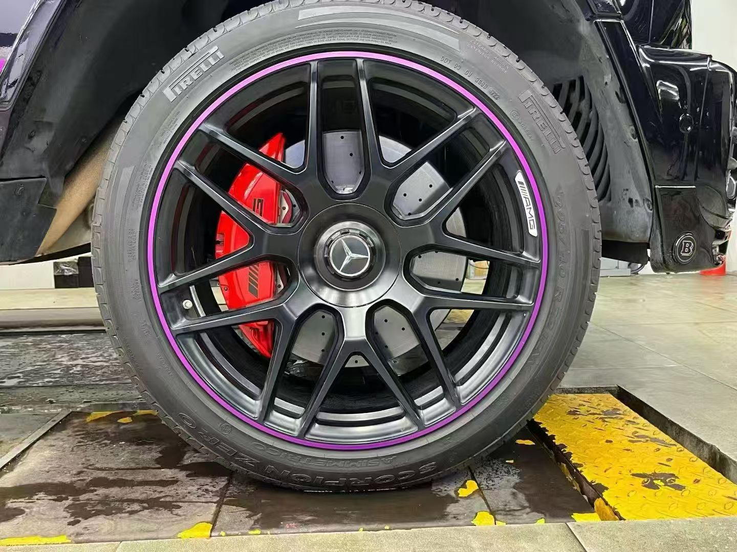 Workshop installation with a red caliper and purple wheel accent